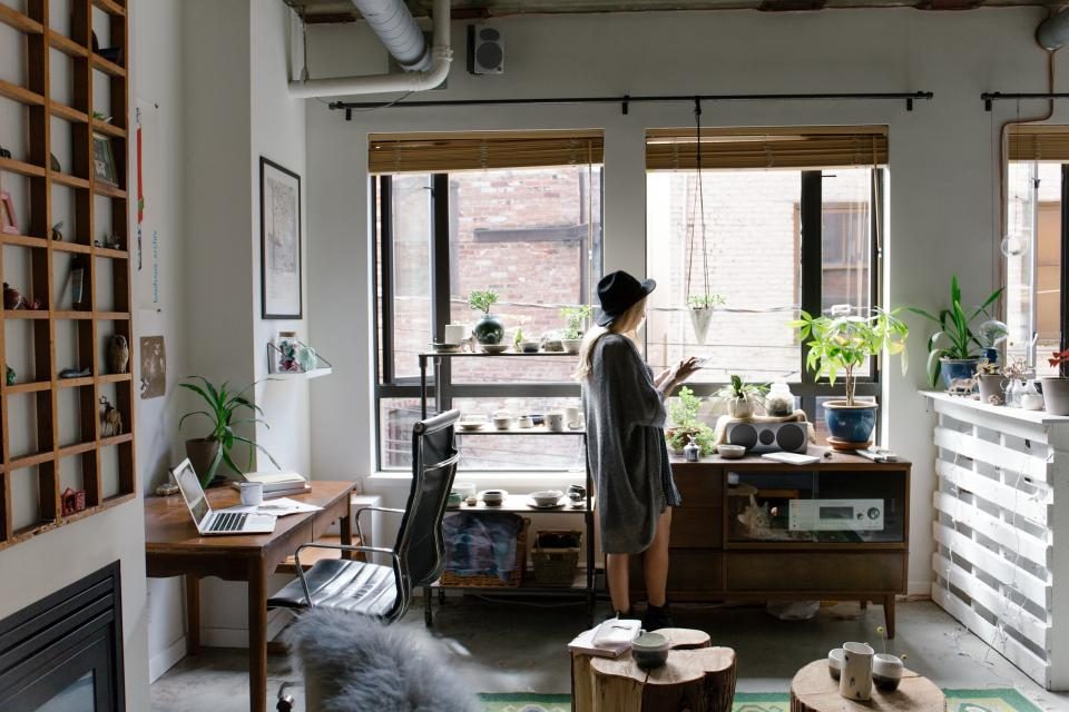A person working at a laptop in a bright home study