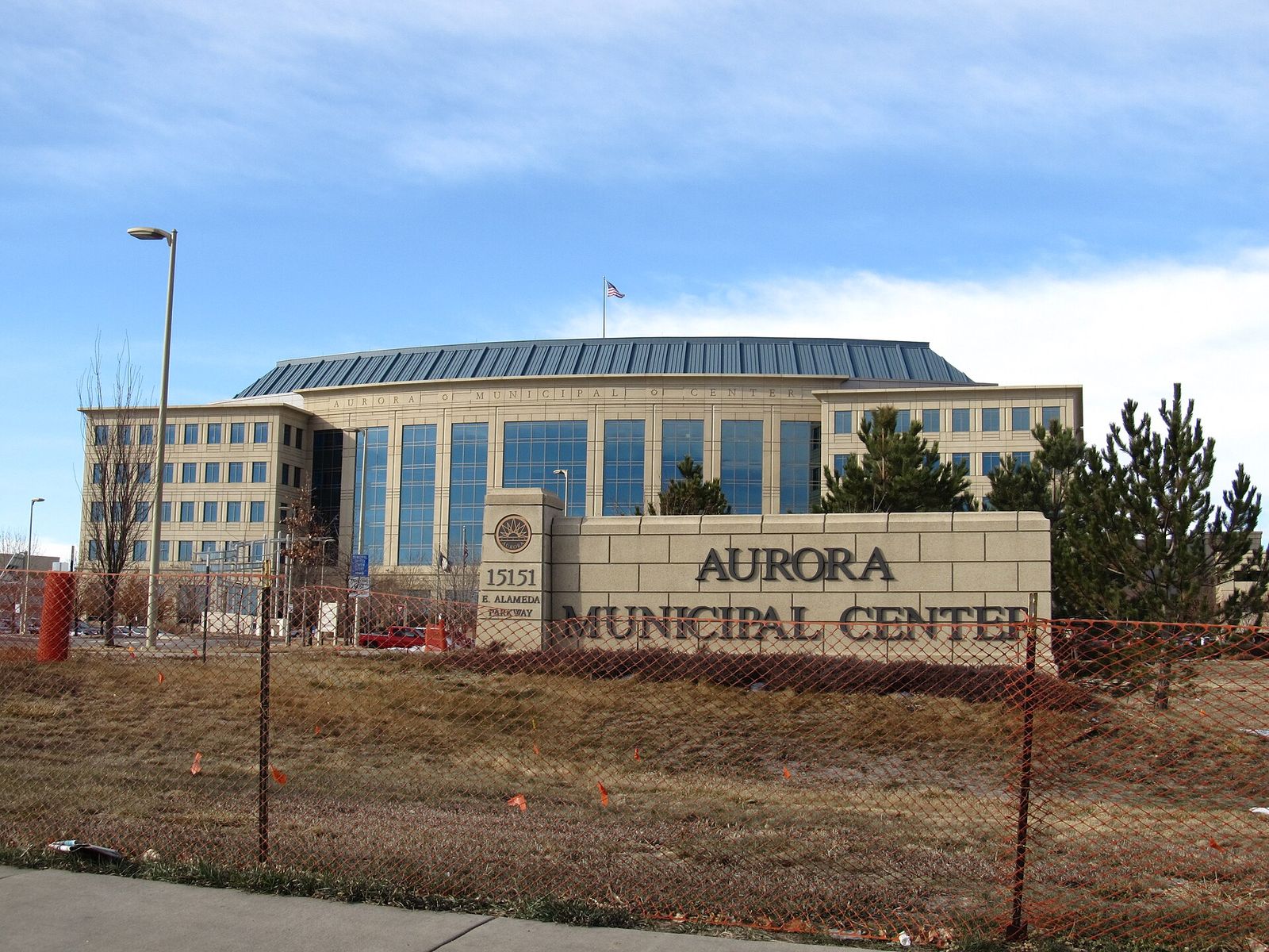 Aurora Municipal Center sign in front of the glass-domed city government building