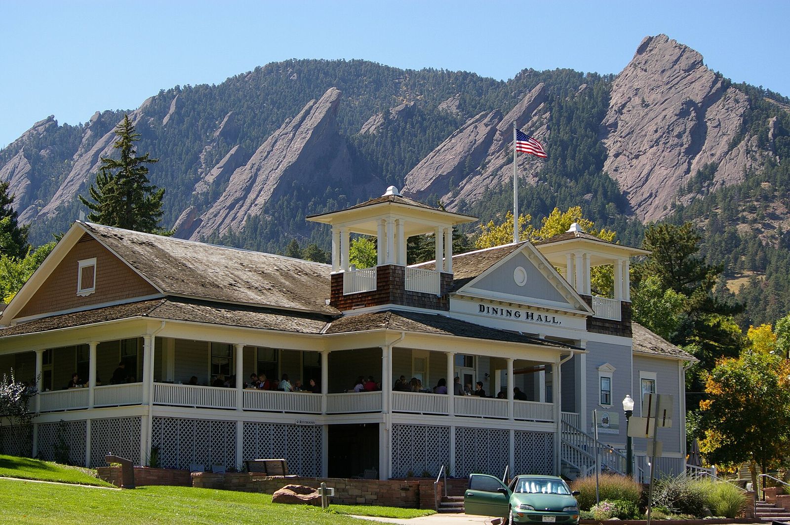 Historic Chautauqua Dining Hall with a wide porch below the Flatirons in Boulder
