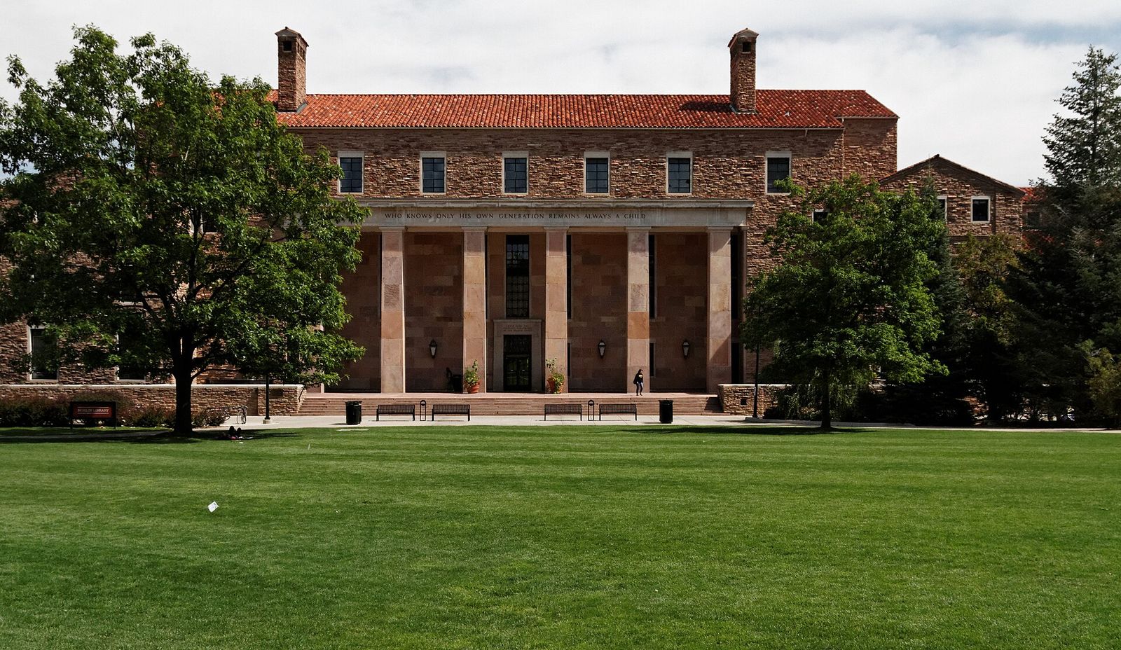 Norlin Library at the University of Colorado Boulder with its stone facade and columns across a green lawn