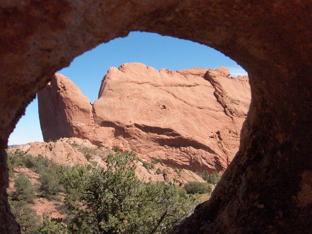 Red sandstone formation at Garden of the Gods seen through a rock opening