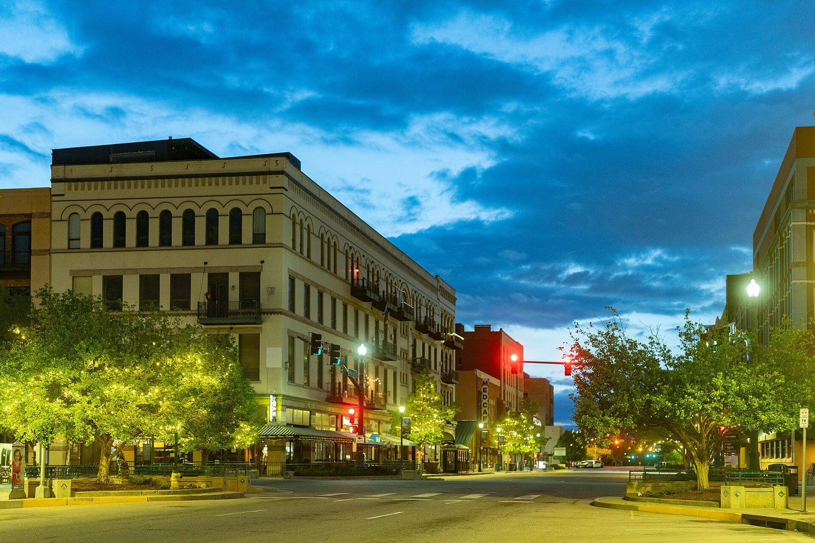 Evening view along Kiowa Street in downtown Colorado Springs with historic buildings and street lights