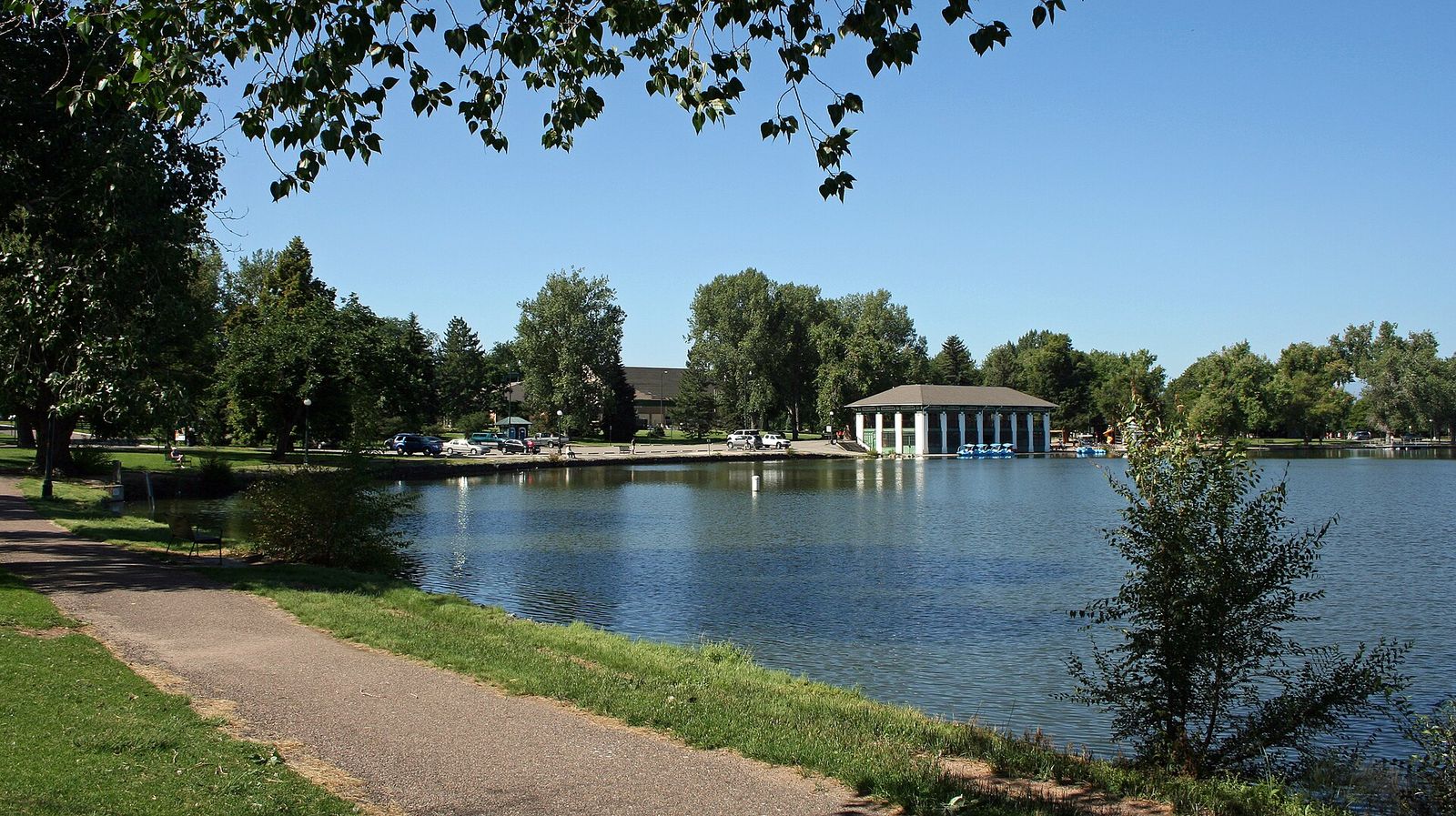 Path along Smith Lake in Washington Park, Denver, with the boathouse across the water