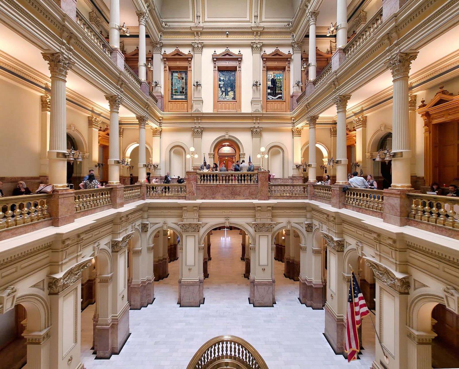 Ornate multi-level rotunda inside the Colorado State Capitol with marble floors and balconies