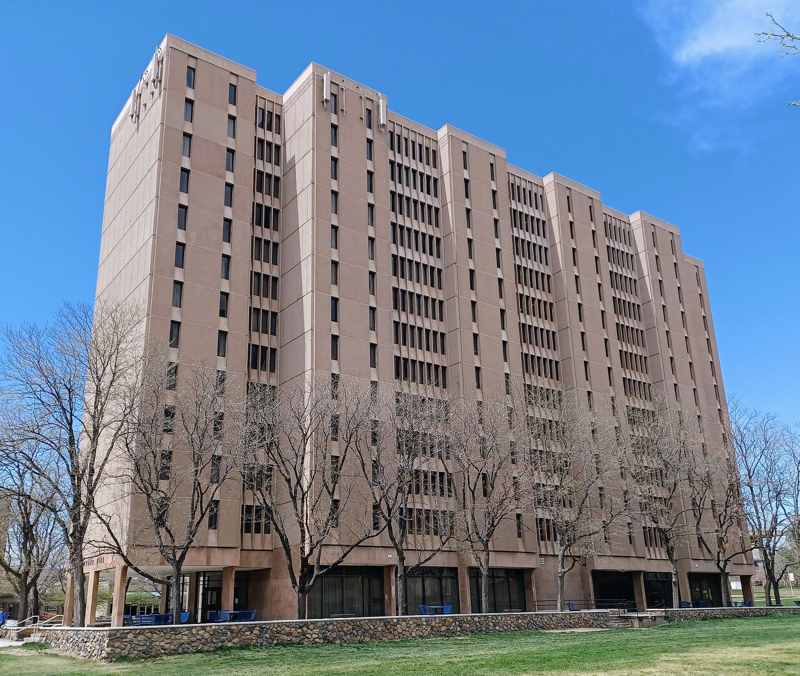 Tall brick Turner Hall residence building at the University of Northern Colorado under a blue sky