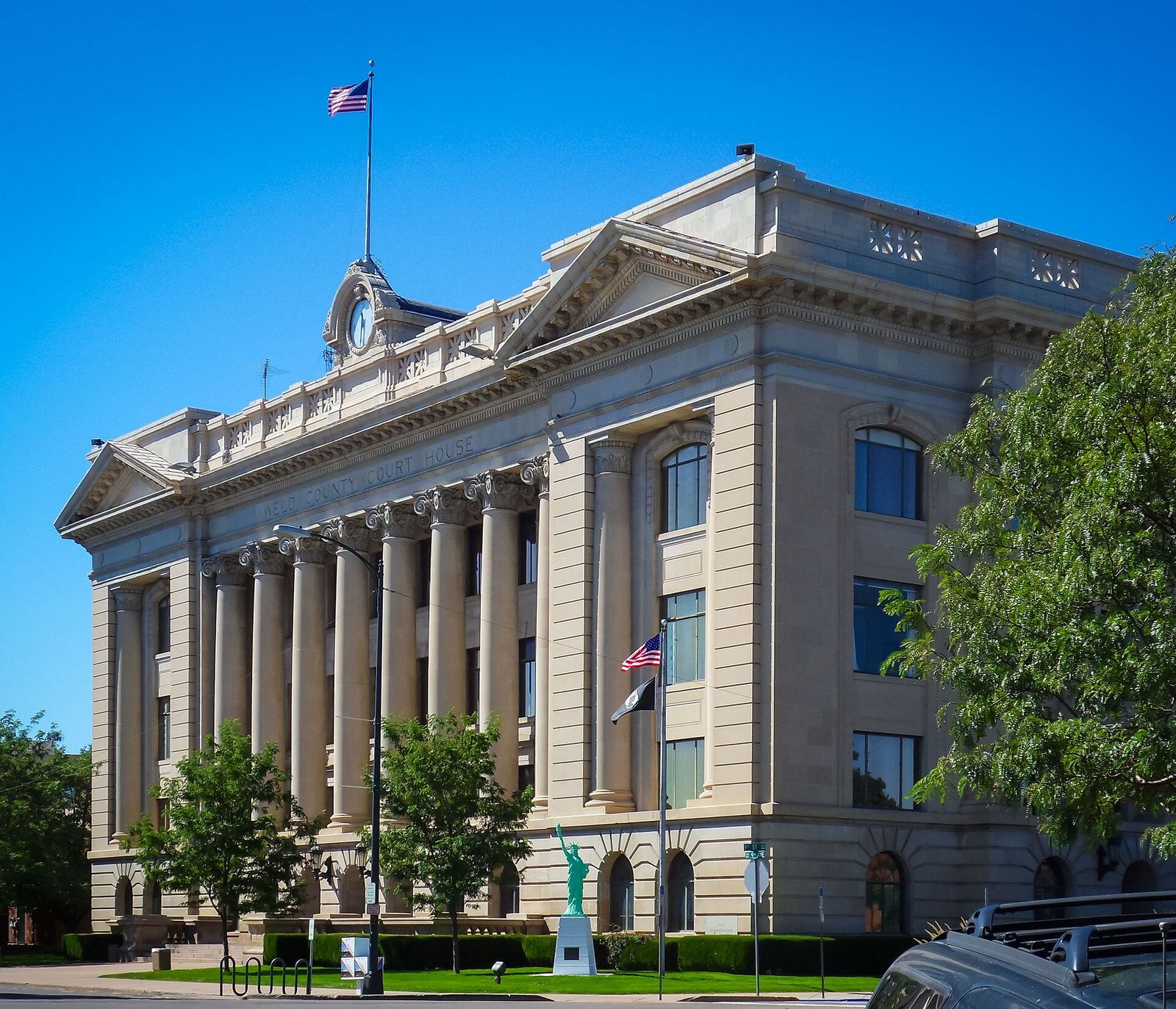 Neoclassical Weld County Courthouse in Greeley with tall columns and a flag on the roof