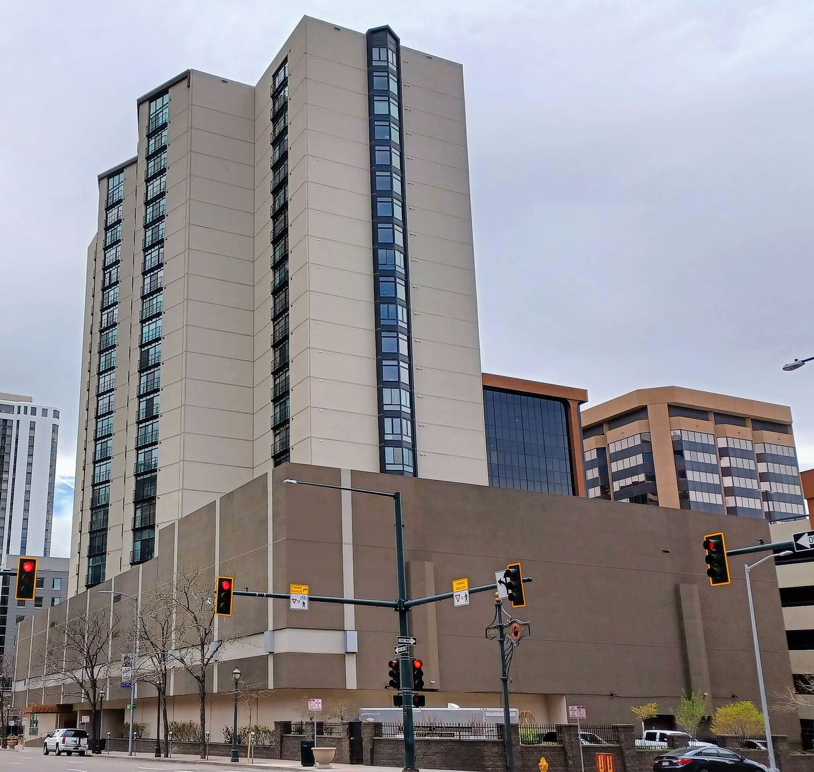 High-rise Windsor Condominiums tower in Denver with a lower commercial building in front