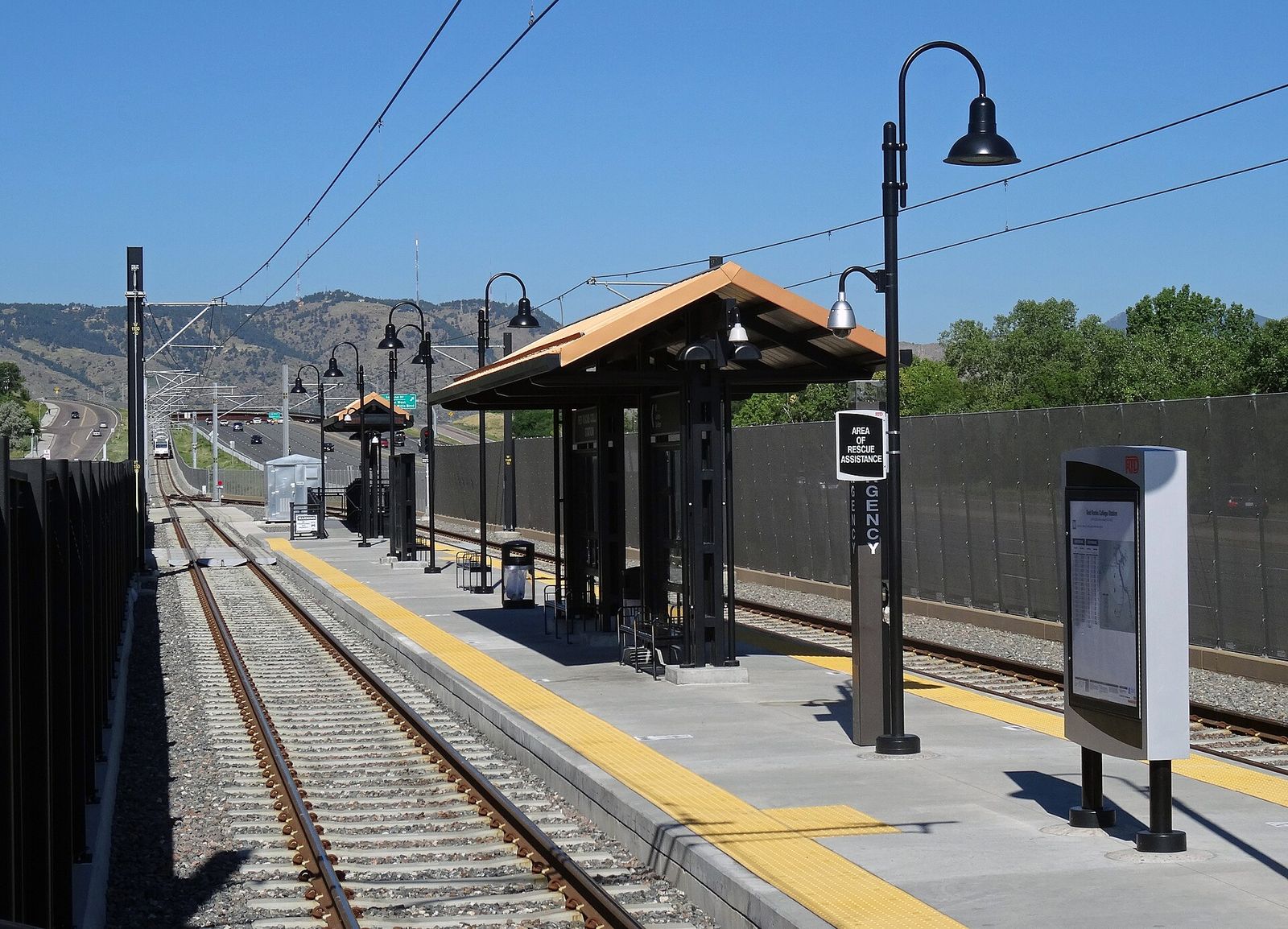 Red Rocks College light rail station platform on the W Line in Lakewood with foothills behind