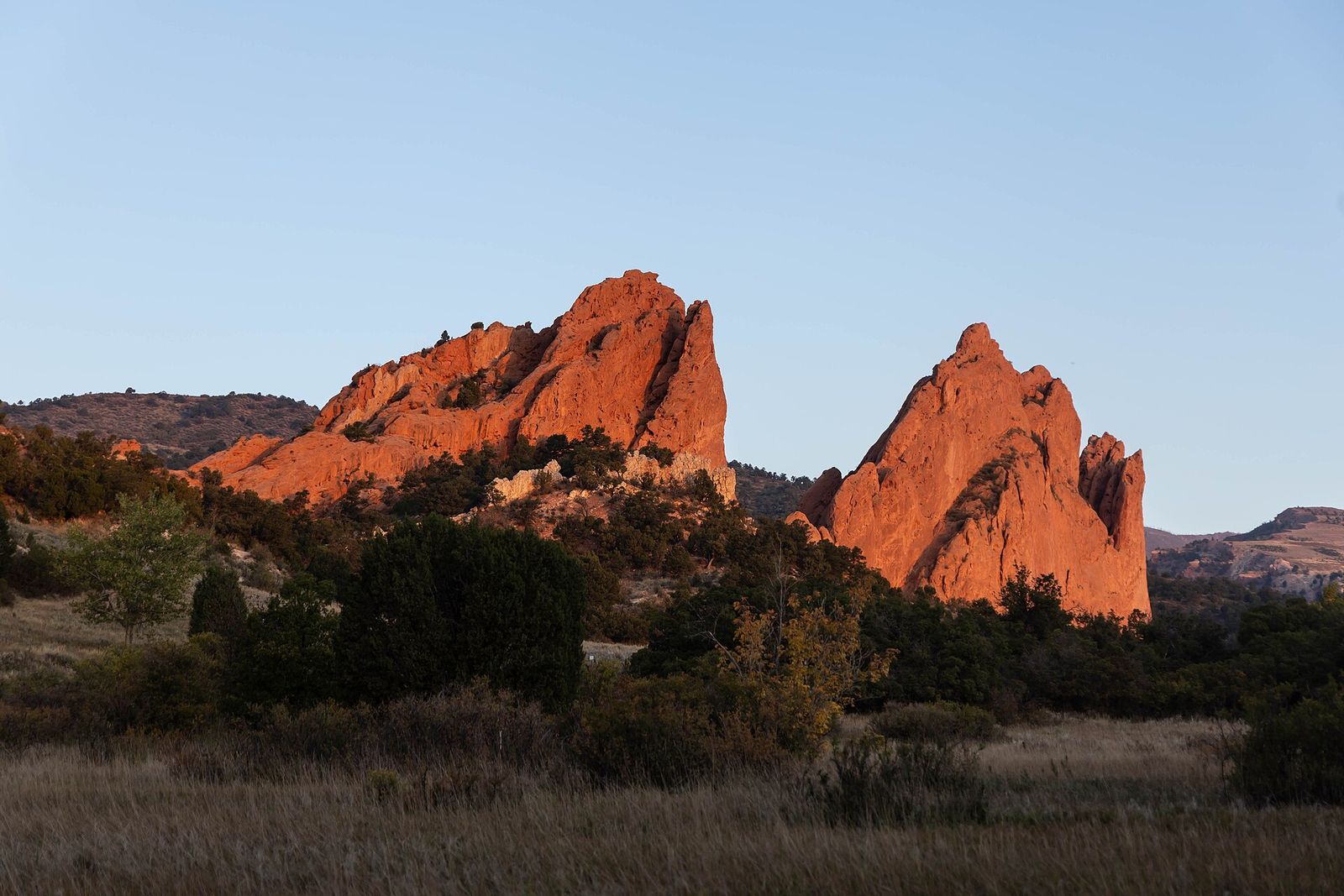 Red sandstone formations at Garden of the Gods in Colorado Springs lit by early sun