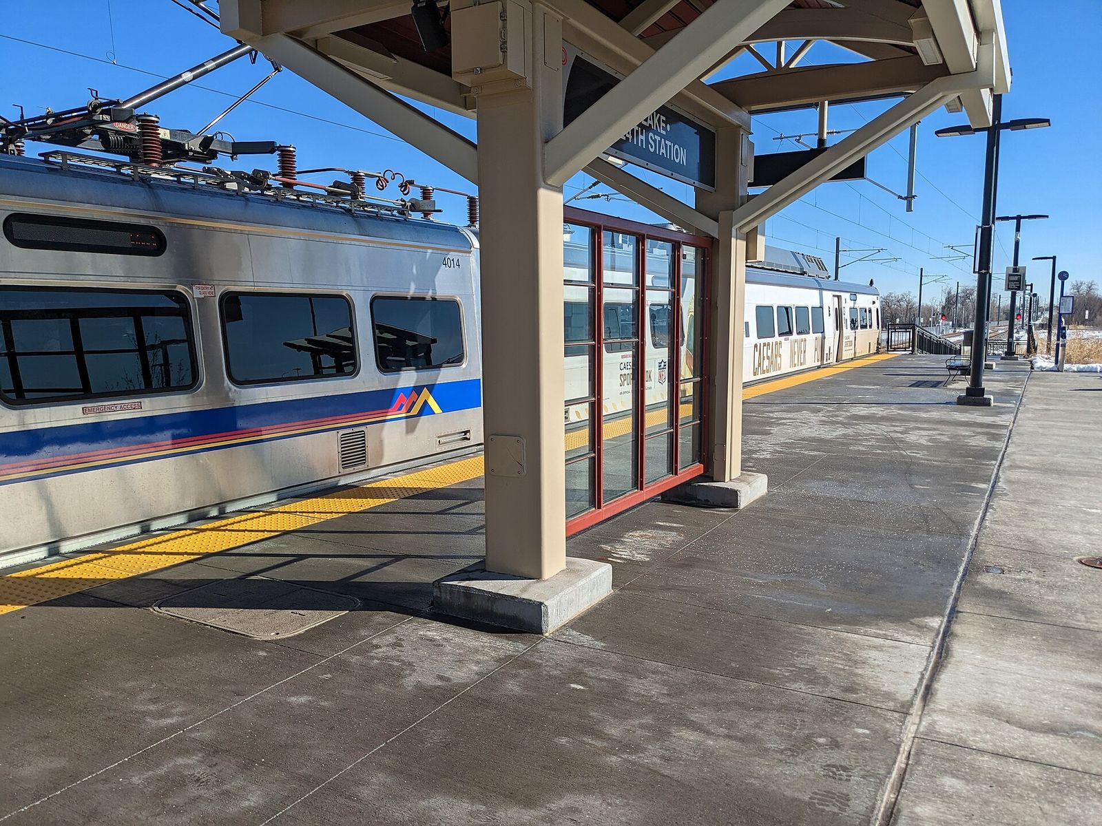 RTD commuter rail train stopped under the canopy at the Eastlake 124th station in Thornton