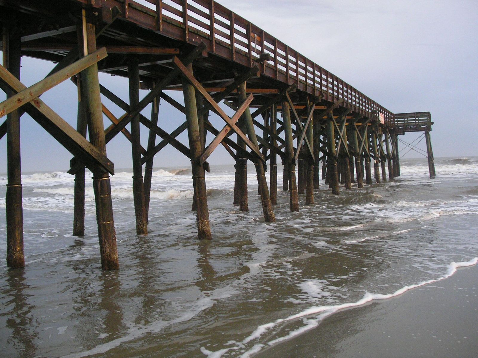 Wooden fishing pier stretching over the surf at Isle of Palms