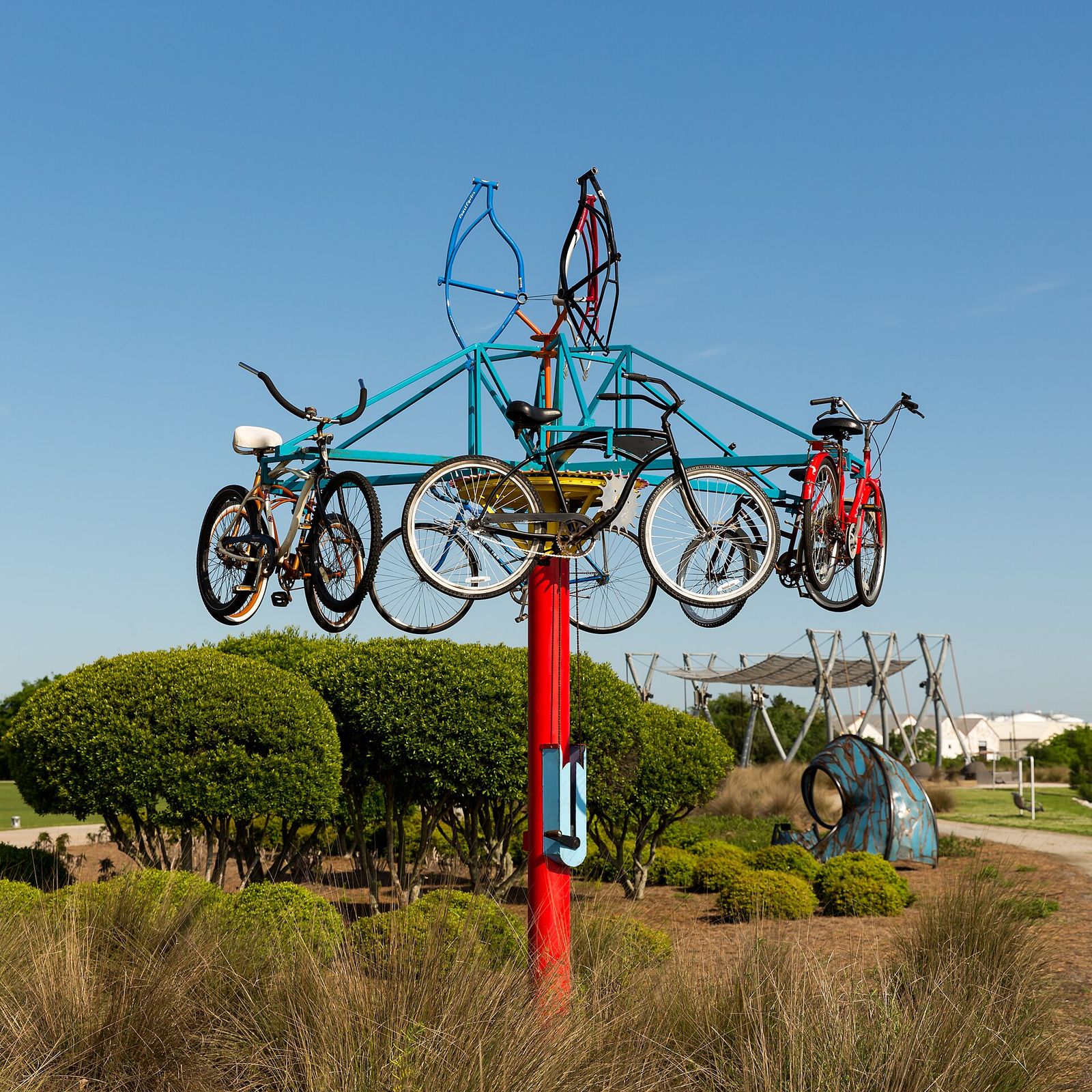 Colorful bicycle sculpture rising above flower beds at Riverfront Park