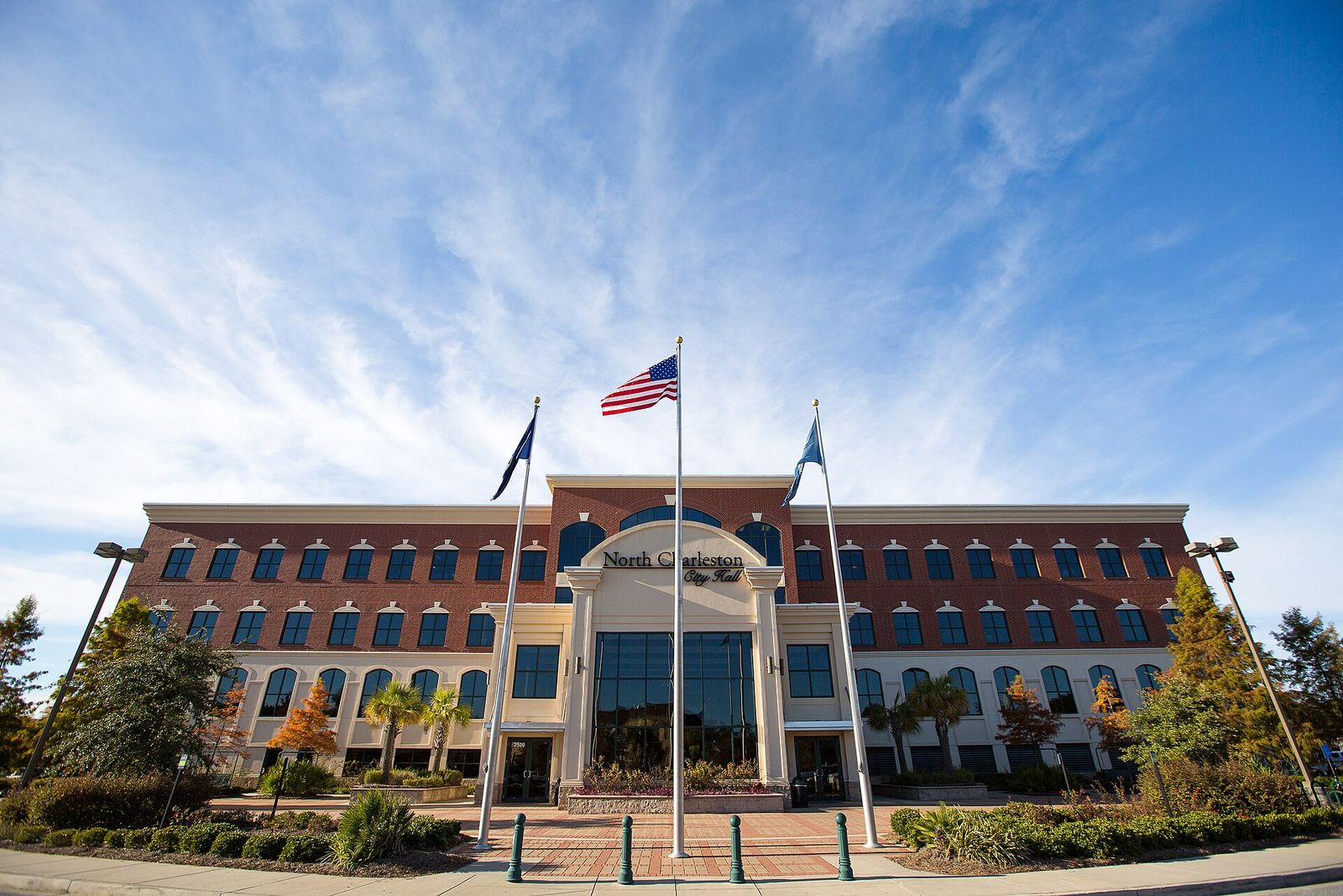 North Charleston City Hall with flags under a blue sky