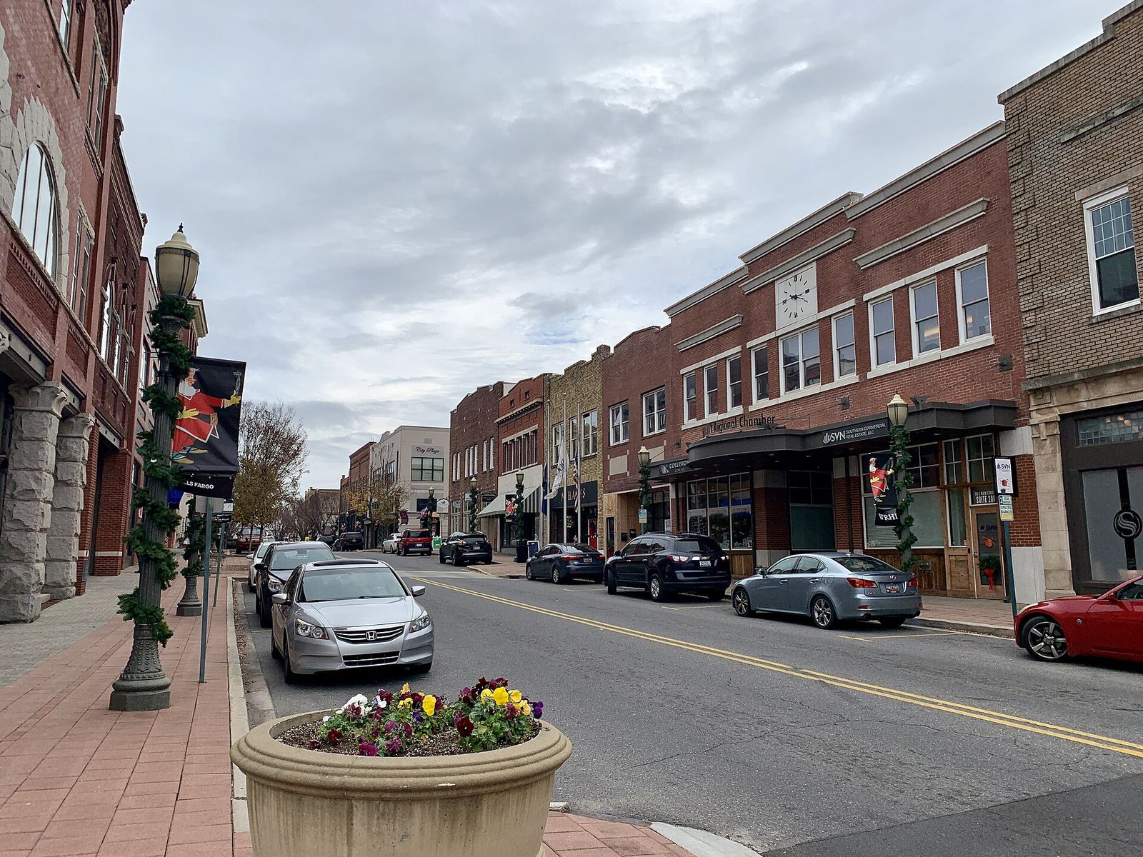 Brick storefronts and parked cars along Main Street in downtown Rock Hill