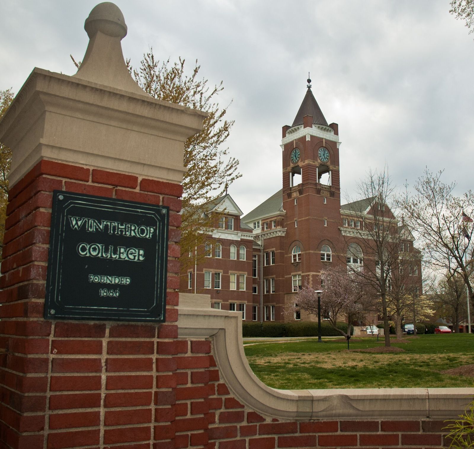Brick clock tower of Tillman Hall behind the Winthrop College entrance gate