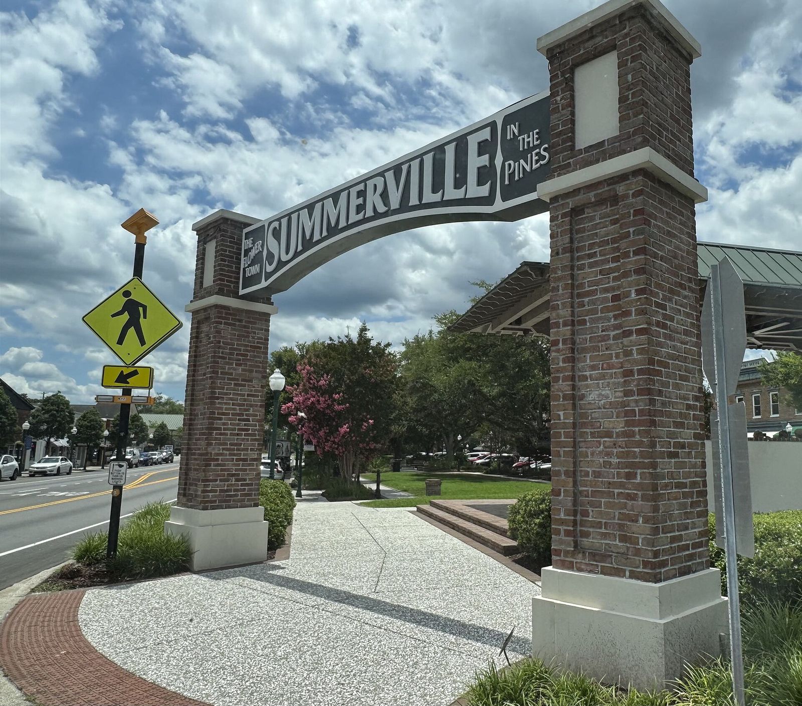Brick gateway arch reading Summerville beside a crosswalk