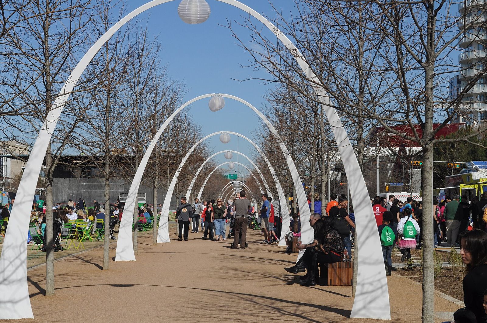 White arches over a busy walkway at Klyde Warren Park in downtown Dallas