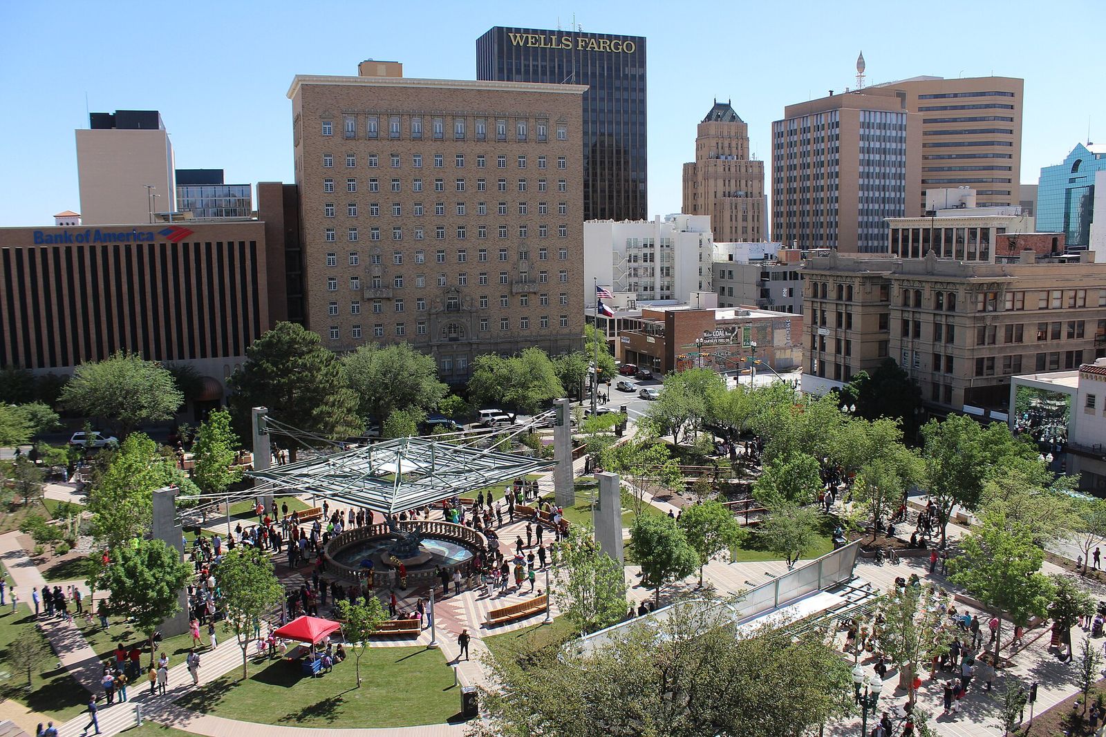 San Jacinto Plaza in downtown El Paso with trees, shade structures and surrounding towers