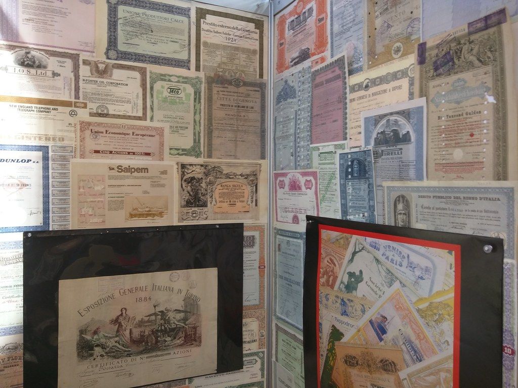Wall covered floor to ceiling with framed antique certificates and documents