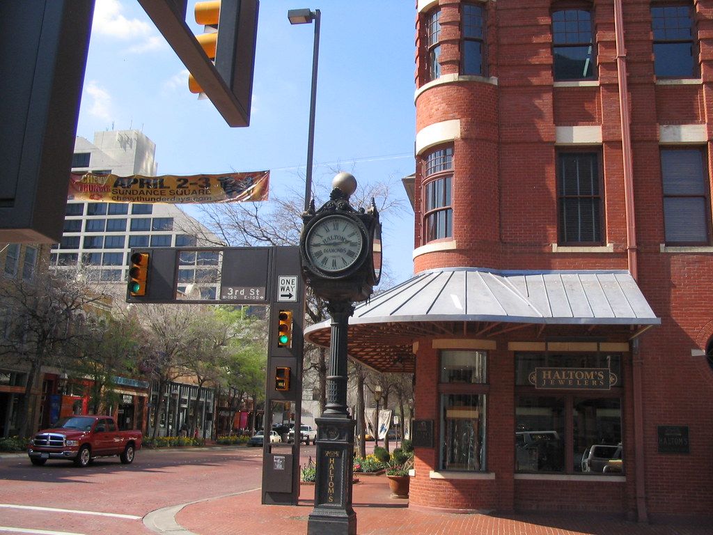 Street clock at a brick-paved intersection in downtown Fort Worth