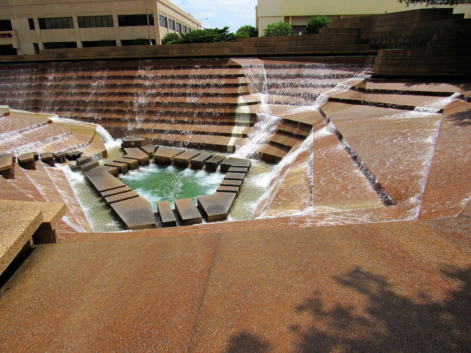 Terraced concrete fountains cascading into a pool at the Fort Worth Water Gardens