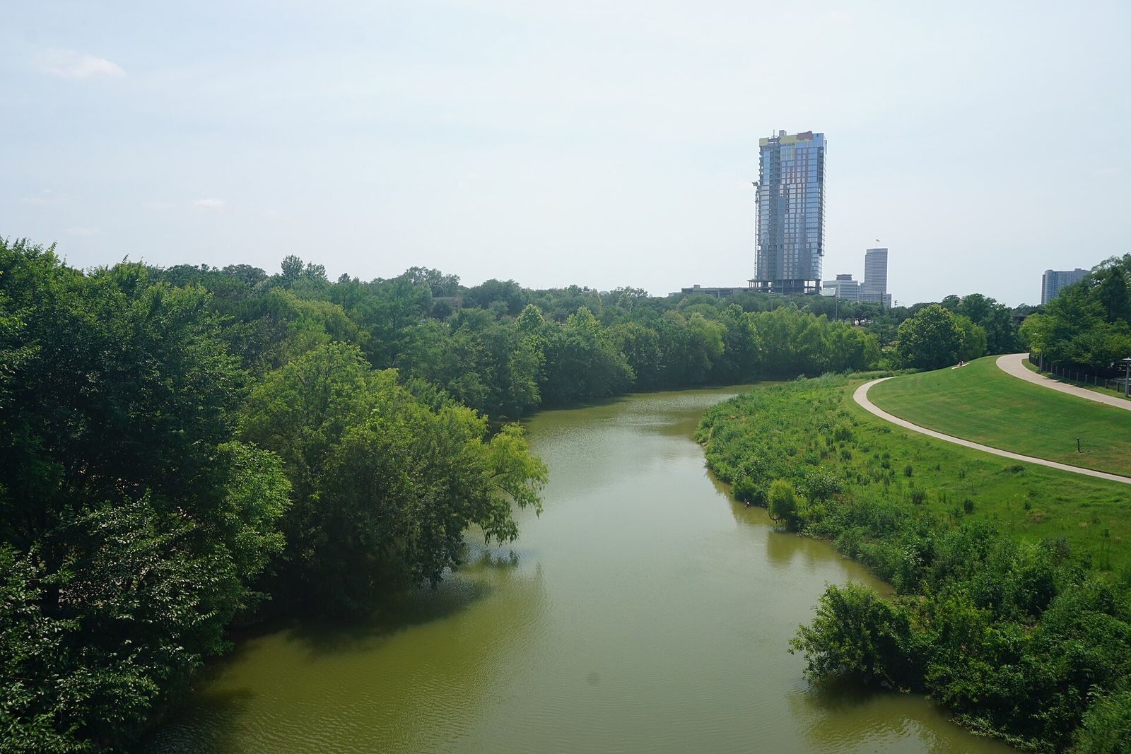Green lawns and trail along Buffalo Bayou Park in Houston