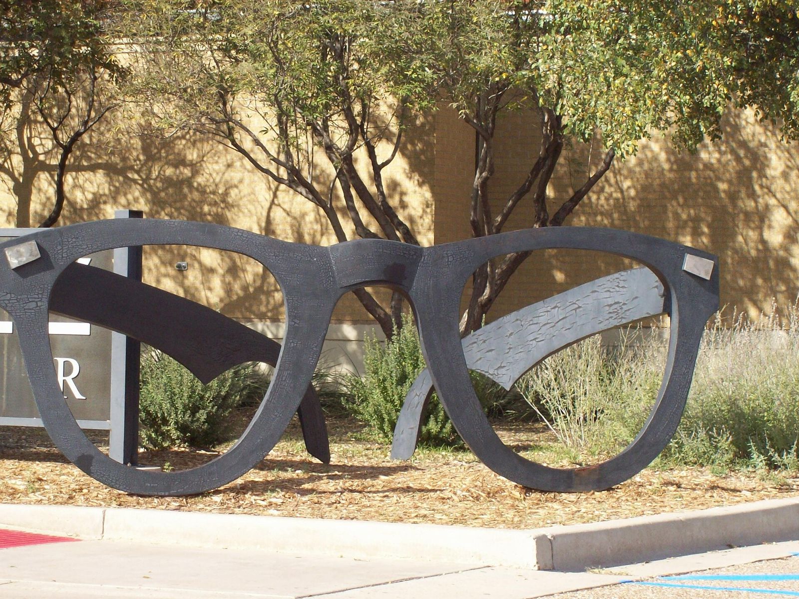 Giant black-rimmed Buddy Holly glasses sculpture outside the Buddy Holly Center