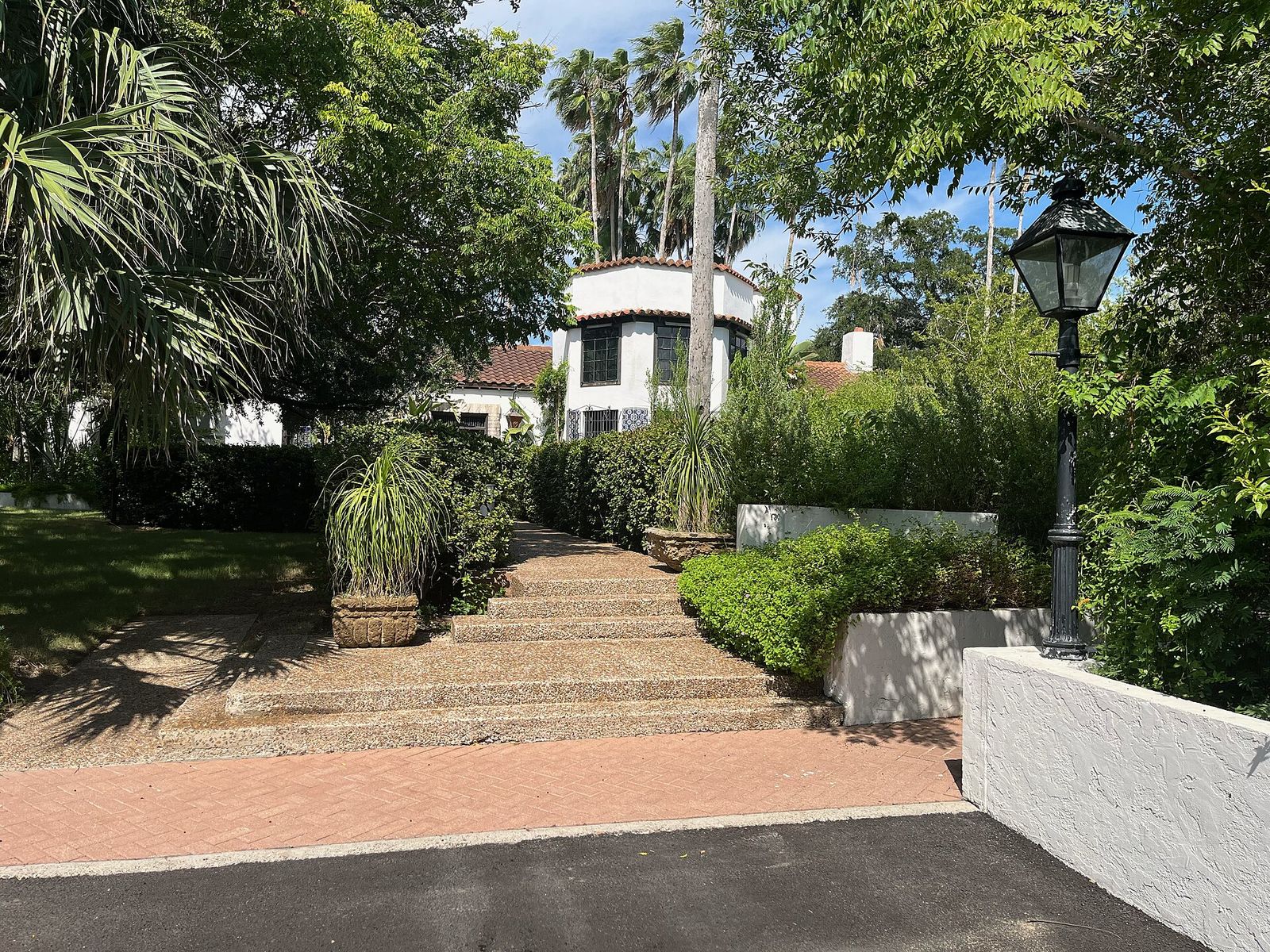 Historic adobe house surrounded by palms and gardens at Quinta Mazatlan in McAllen