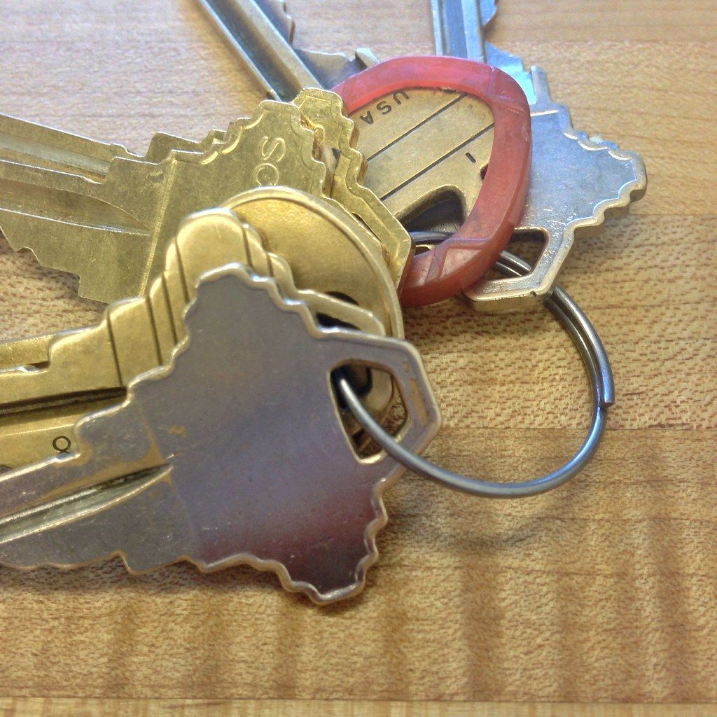 Ring of brass apartment keys on a wooden table
