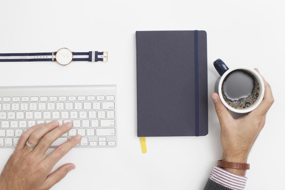 A desk with a notebook, diary and pen ready for an appointment