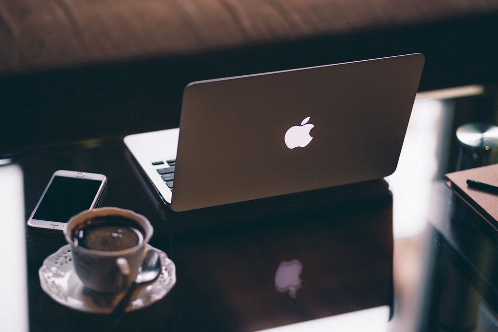 A laptop and phone open on a desk while checking a website