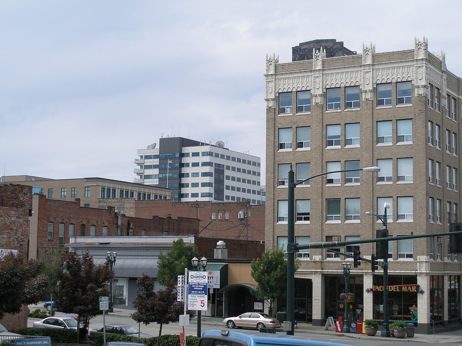 A downtown Everett street with brick buildings and parked cars