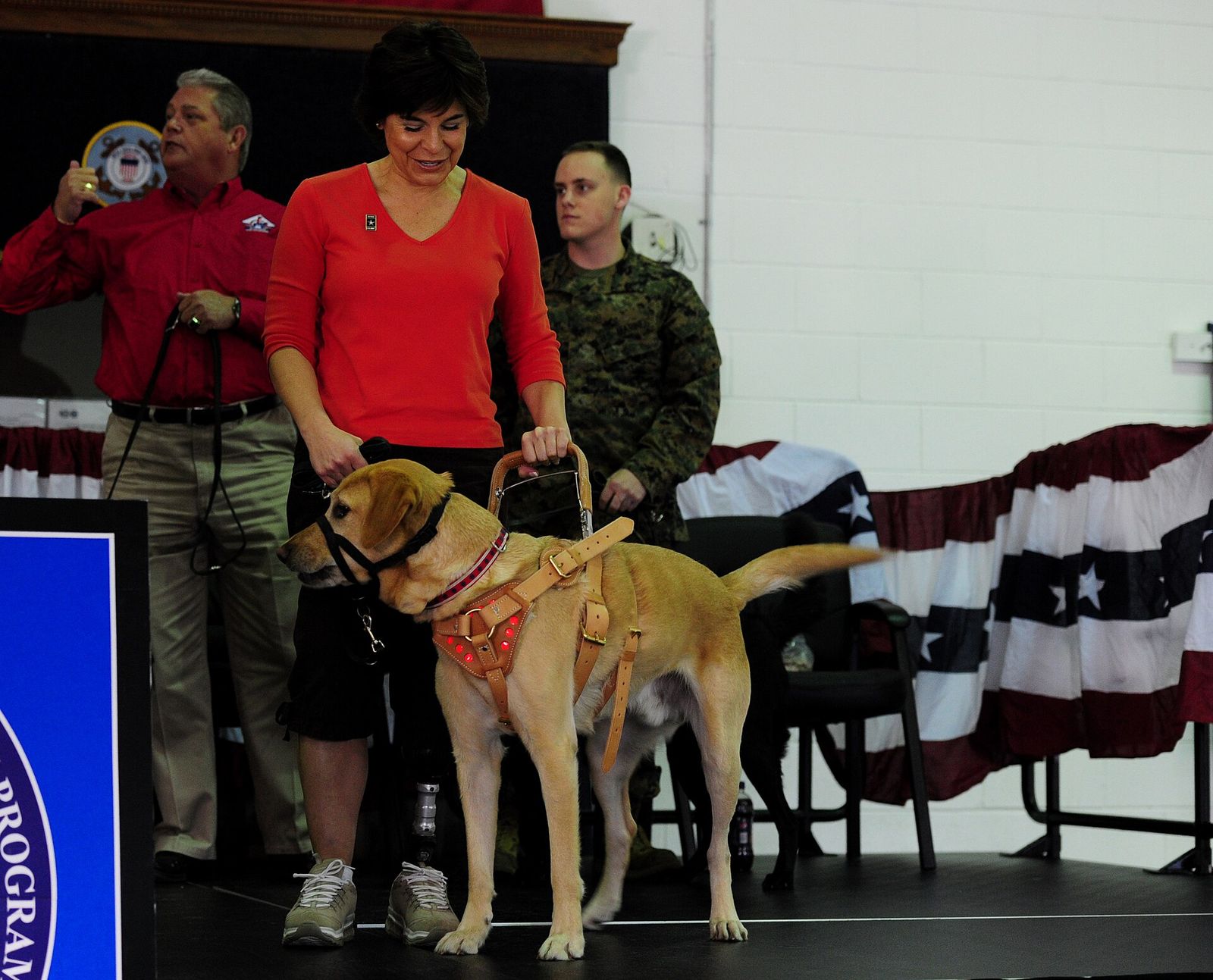 A service dog placement ceremony with a yellow labrador and its new handler