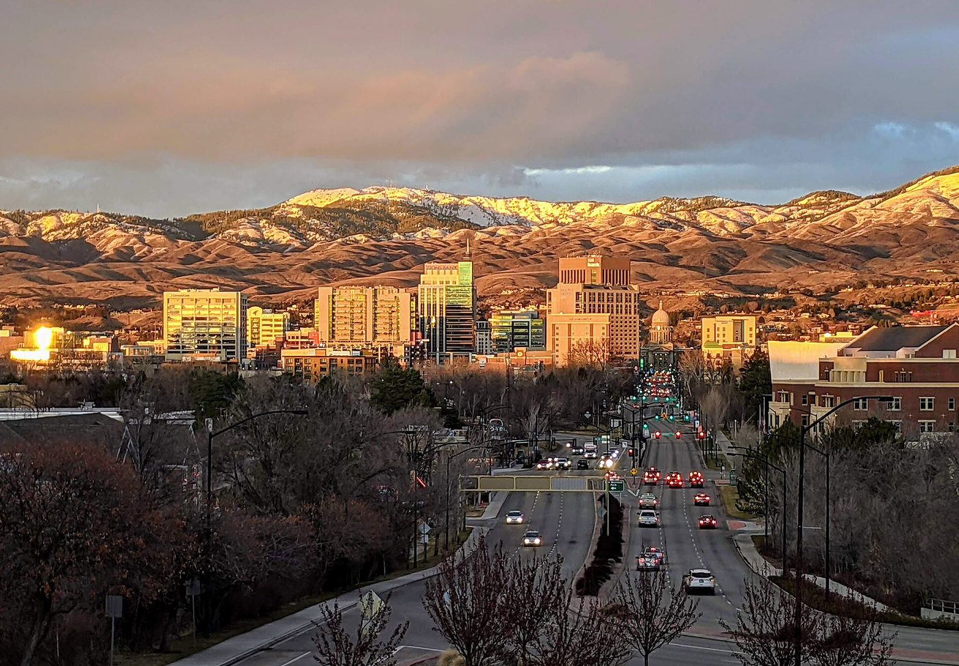 Downtown Boise at sunset, with the Idaho State Capitol and the foothills behind it
