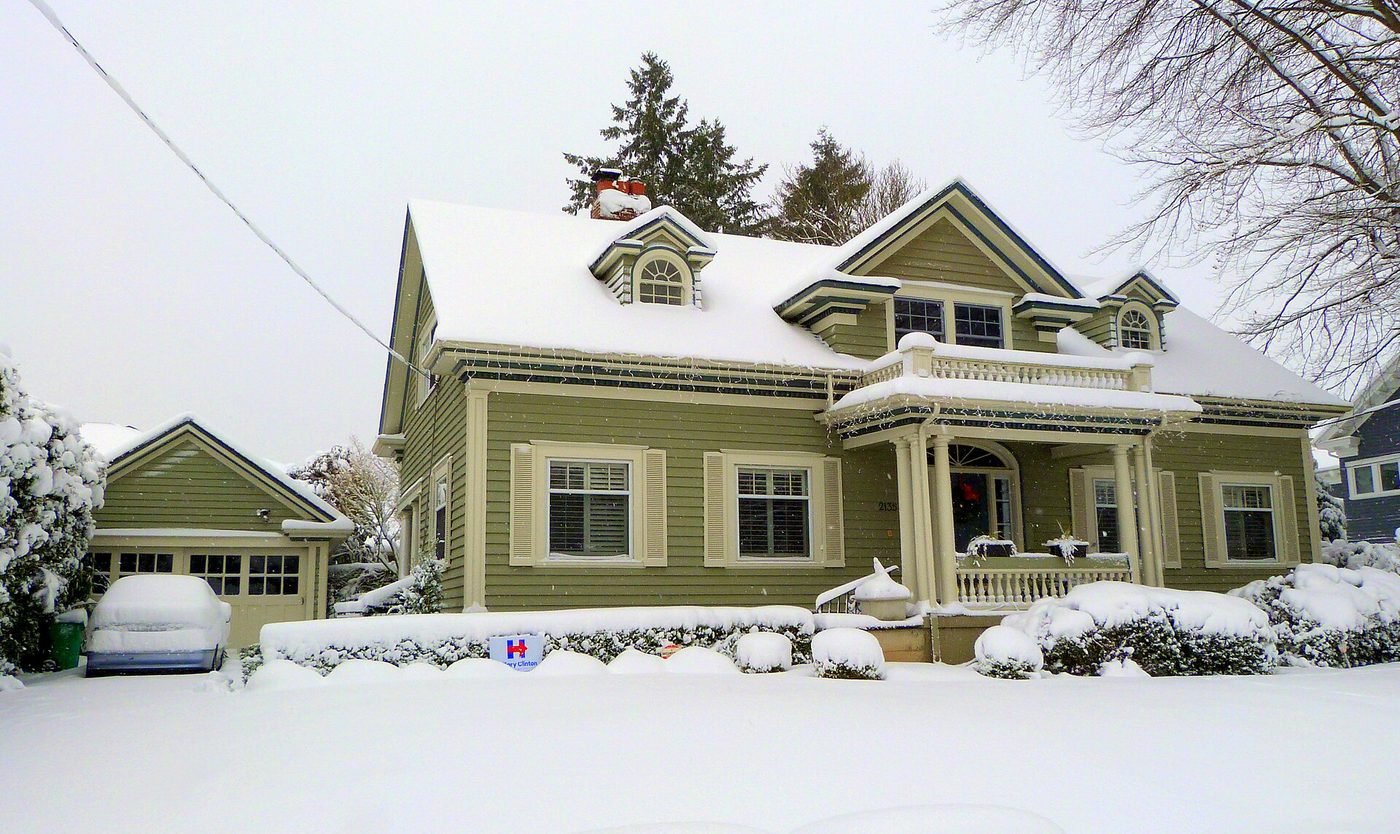 A Victorian house in a Portland historic district under snow