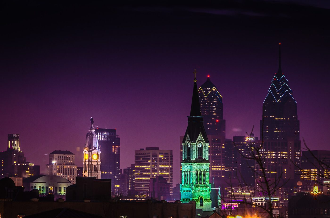 The Philadelphia skyline at dusk with the illuminated City Hall tower