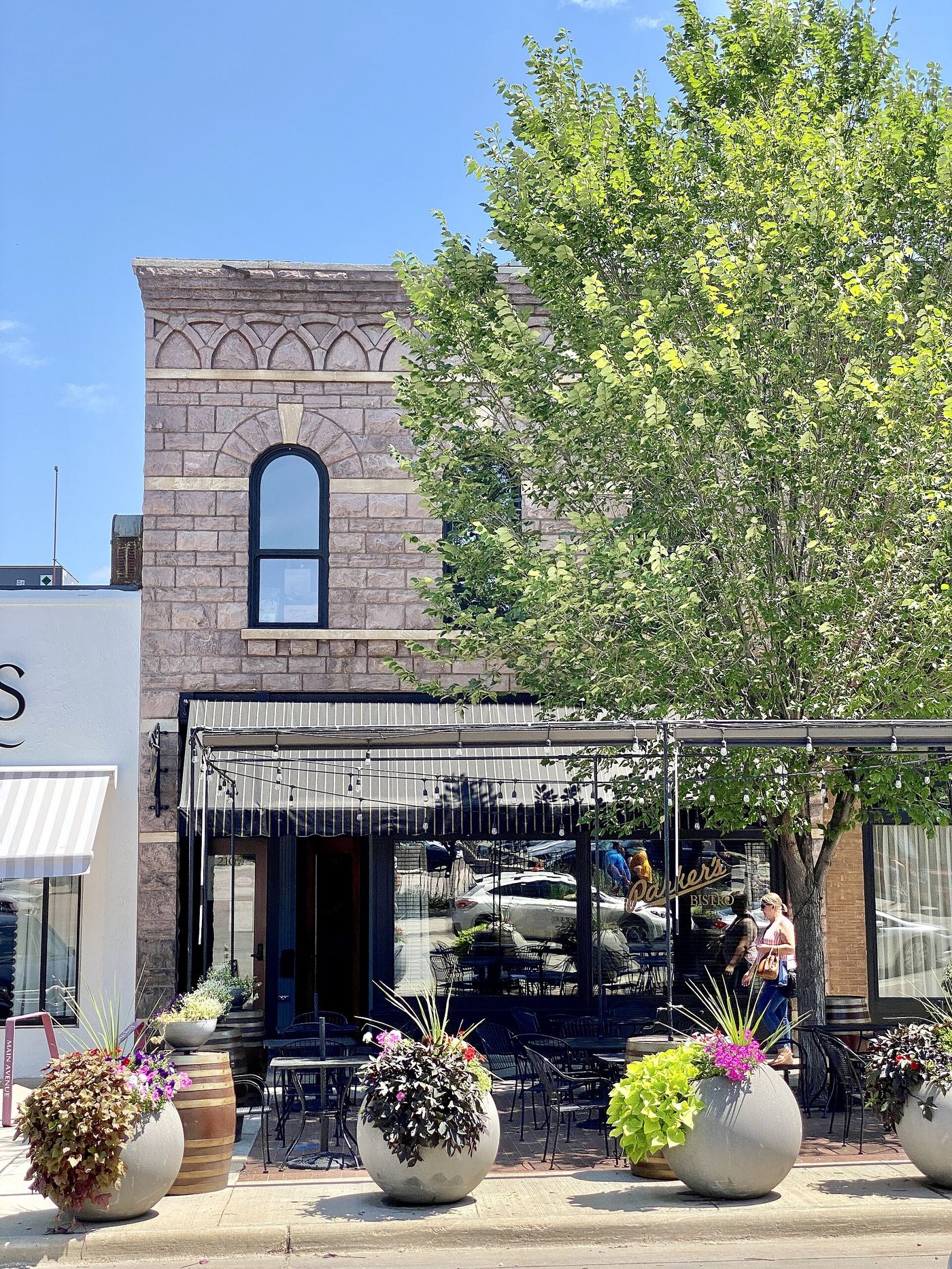 A brick commercial block on Main Avenue in Sioux Falls in summer
