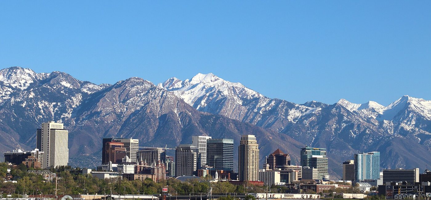 The Salt Lake City skyline with the snow-covered Wasatch range behind it