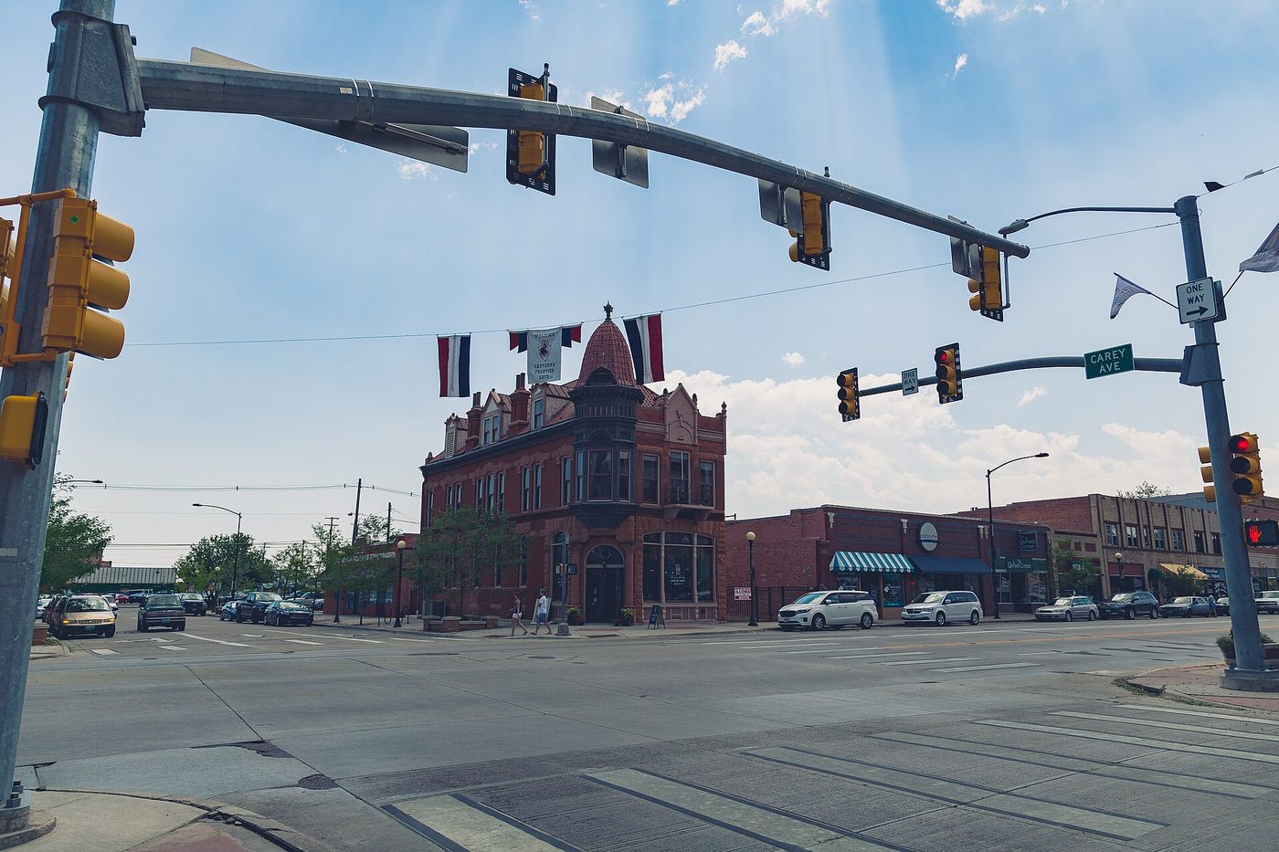A downtown Cheyenne intersection, a red-brick corner building beneath traffic signals